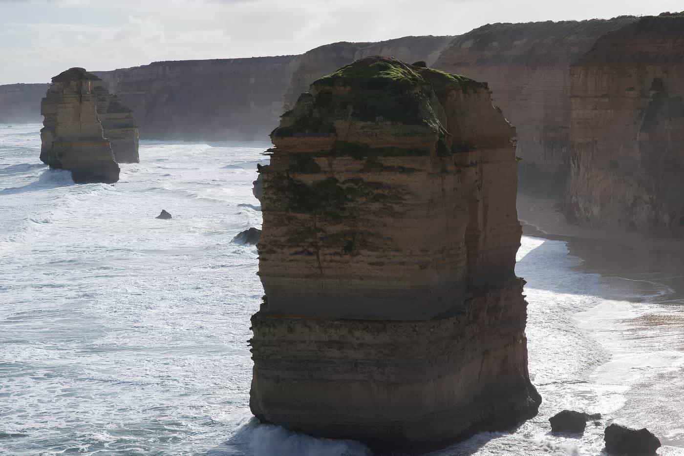 Limestone stacks of the Twelve Apostles standing in the sea below cliffs