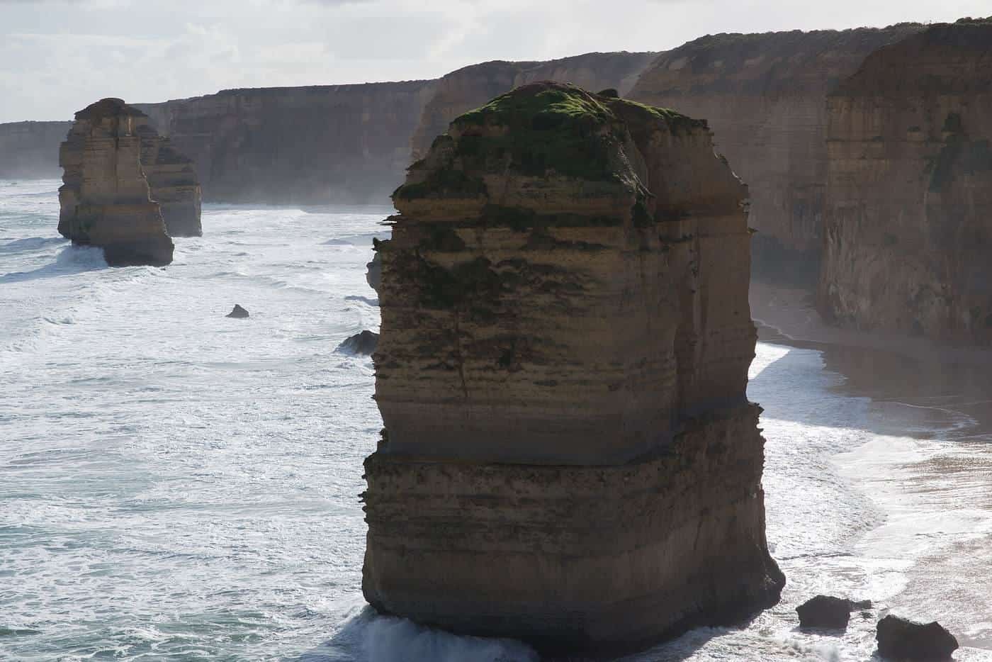 Limestone stacks of the Twelve Apostles standing in the sea below cliffs