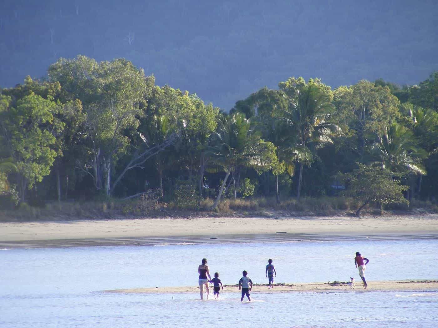 Children playing on a sandy tropical beach